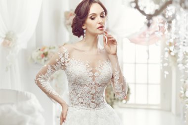 The beautiful woman posing in a wedding dress