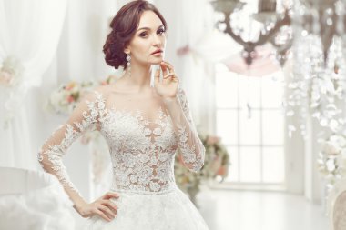 The beautiful woman posing in a wedding dress