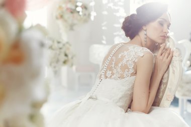 The beautiful woman posing in a wedding dress
