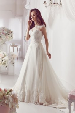 The beautiful woman posing in a wedding dress