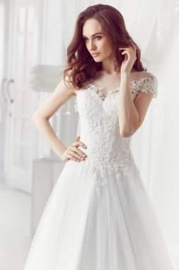 The beautiful woman posing in a wedding dress