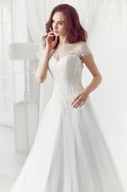 The beautiful woman posing in a wedding dress
