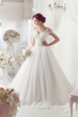 The beautiful woman posing in a wedding dress