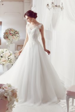 The beautiful woman posing in a wedding dress