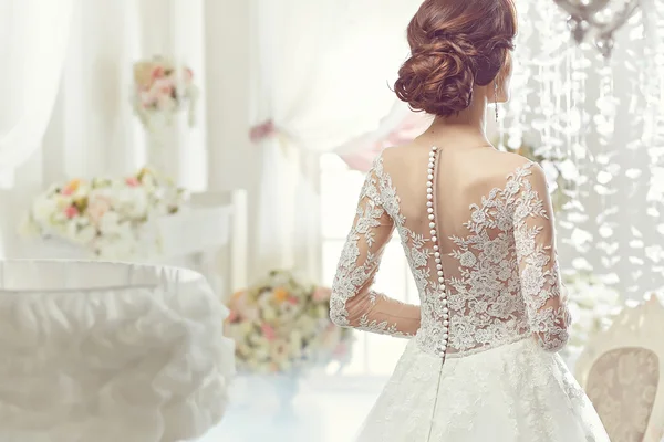 The beautiful woman posing in a wedding dress — 스톡 사진