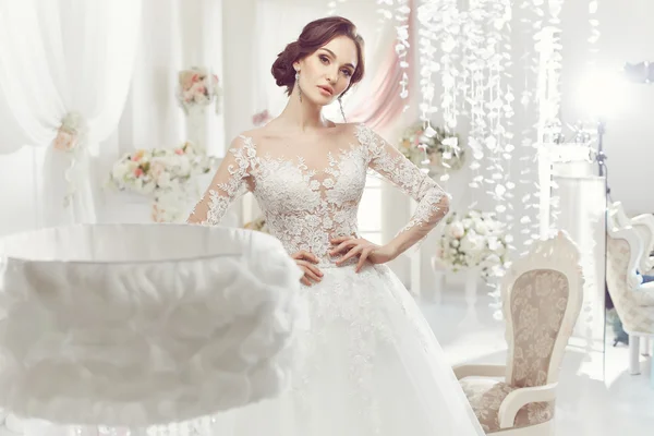 The beautiful woman posing in a wedding dress — Stock Fotó