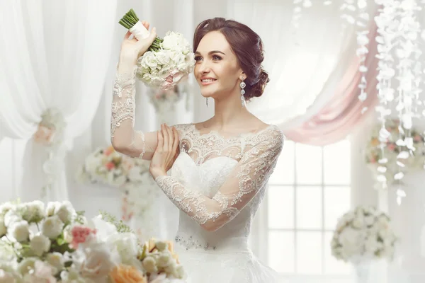 A bela mulher posando em um vestido de noiva — Fotografia de Stock