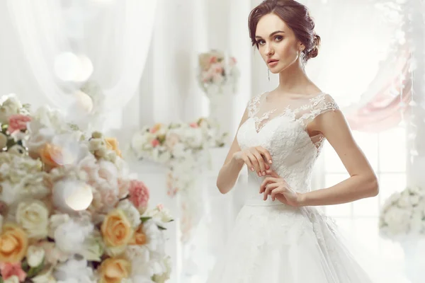 The beautiful woman posing in a wedding dress — Stok fotoğraf