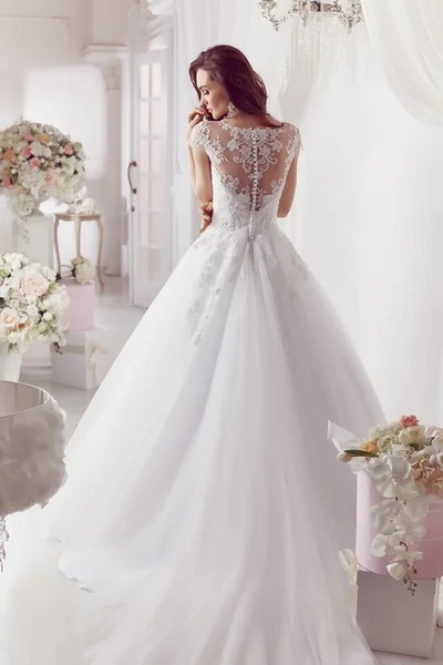 The beautiful woman posing in a wedding dress