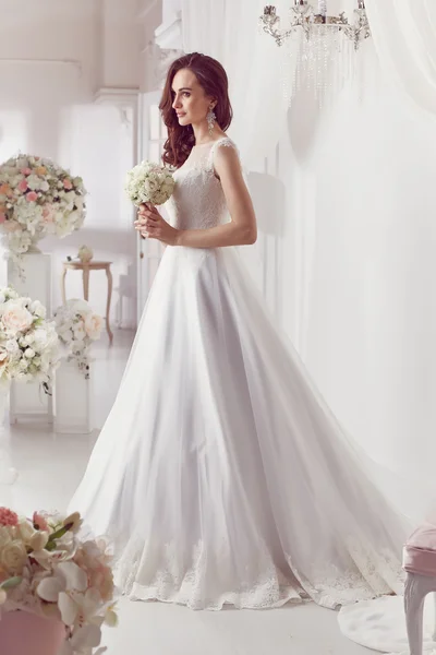 The beautiful woman posing in a wedding dress — Stock Fotó