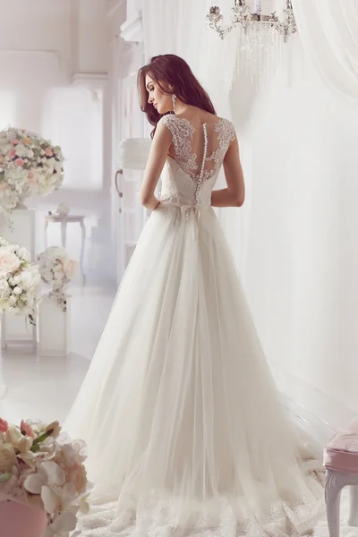 The beautiful woman posing in a wedding dress — 스톡 사진