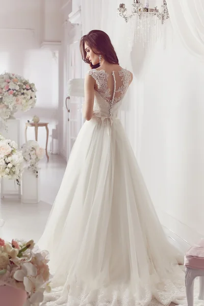 The beautiful woman posing in a wedding dress — 스톡 사진