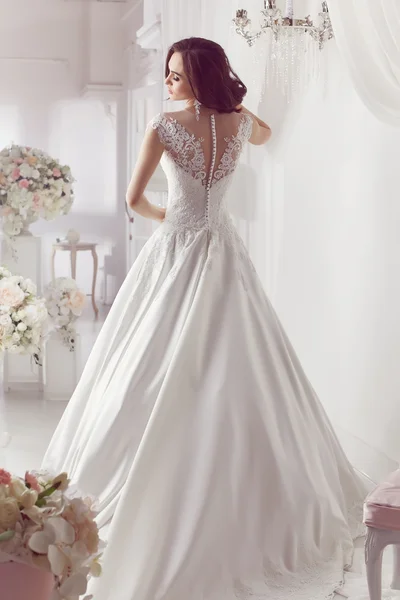 La bella donna in posa in un abito da sposa — Foto Stock