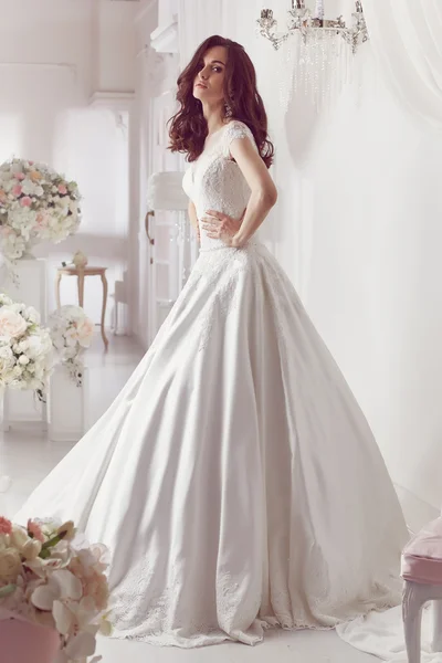 The beautiful woman posing in a wedding dress — 스톡 사진