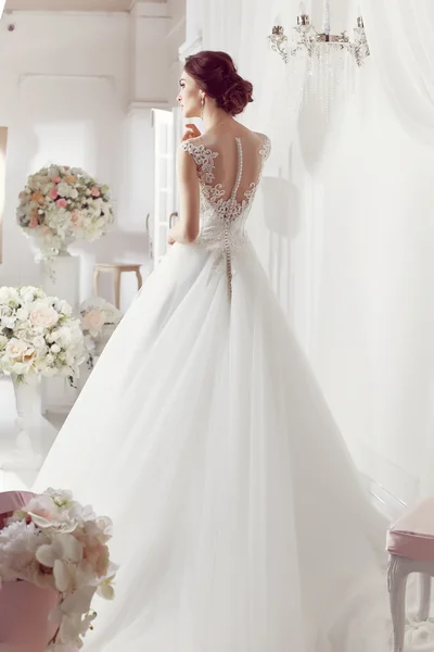 The beautiful woman posing in a wedding dress — Stock Fotó