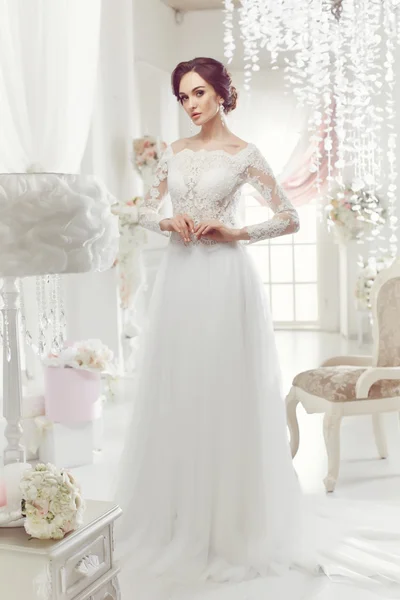 The beautiful woman posing in a wedding dress — 스톡 사진