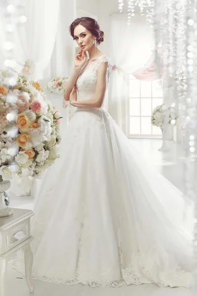 The beautiful woman posing in a wedding dress — 스톡 사진