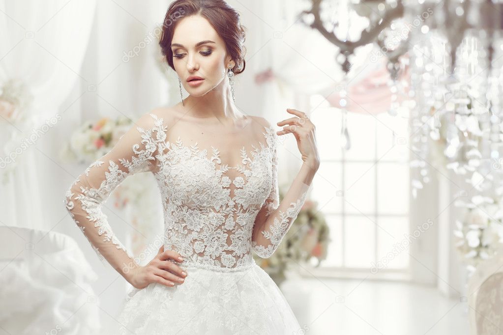 The beautiful woman posing in a wedding dress