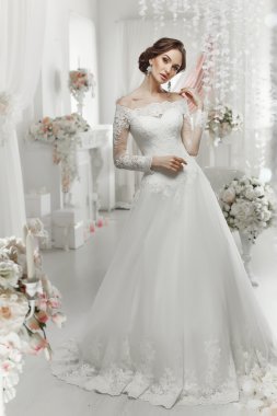 The beautiful woman posing in a wedding dress