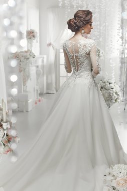 The beautiful woman posing in a wedding dress