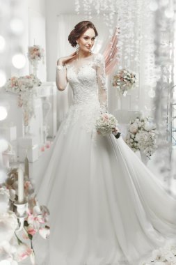 The beautiful woman posing in a wedding dress