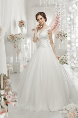 The beautiful woman posing in a wedding dress