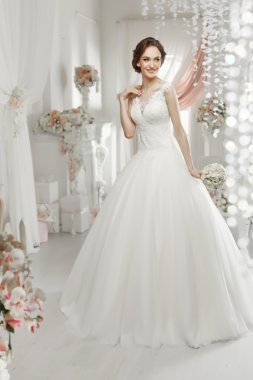 The beautiful woman posing in a wedding dress