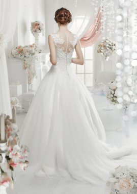 The beautiful woman posing in a wedding dress