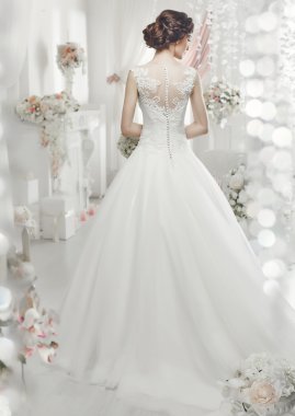 The beautiful woman posing in a wedding dress