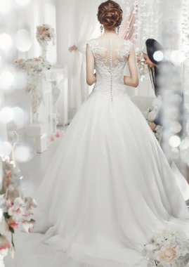 The beautiful woman posing in a wedding dress