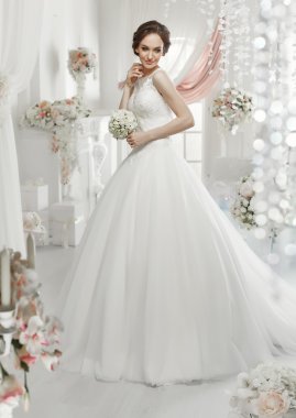 The beautiful woman posing in a wedding dress