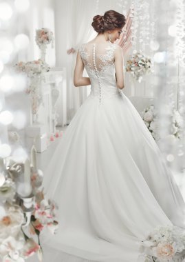 The beautiful woman posing in a wedding dress