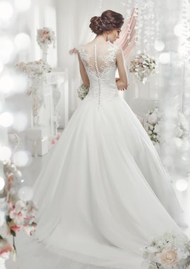 The beautiful woman posing in a wedding dress