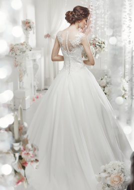 The beautiful woman posing in a wedding dress