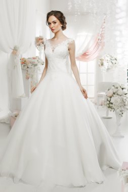 The beautiful woman posing in a wedding dress