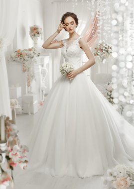 The beautiful woman posing in a wedding dress