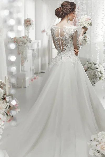 The beautiful woman posing in a wedding dress — 스톡 사진