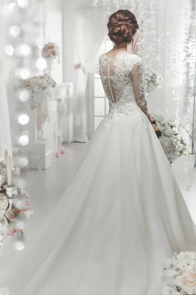 The beautiful woman posing in a wedding dress — 스톡 사진