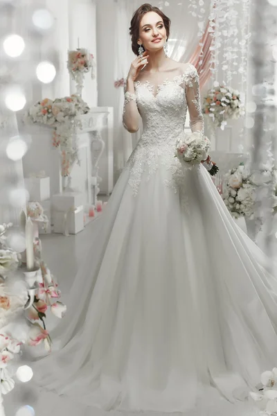 The beautiful woman posing in a wedding dress — 스톡 사진