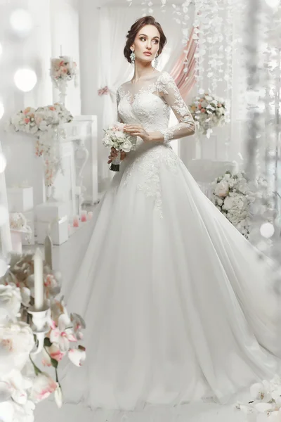 The beautiful woman posing in a wedding dress — 스톡 사진