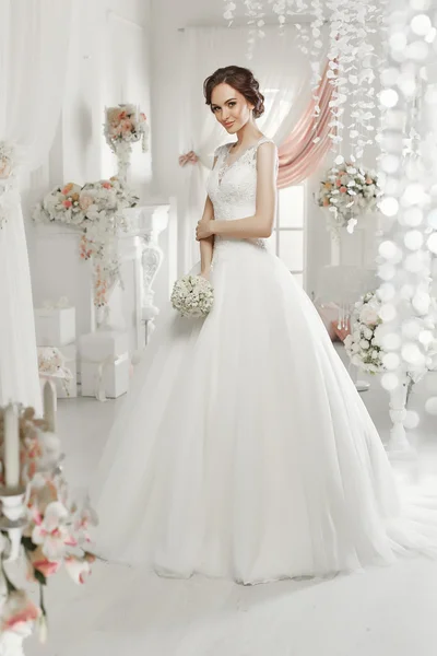 The beautiful woman posing in a wedding dress — Stock Fotó