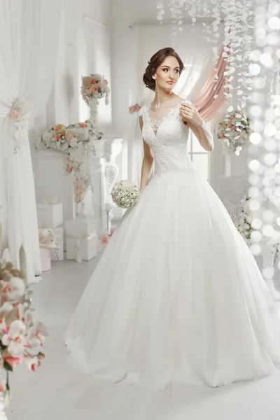 The beautiful woman posing in a wedding dress — 스톡 사진