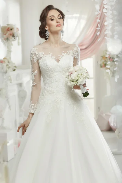 The beautiful woman posing in a wedding dress — 스톡 사진