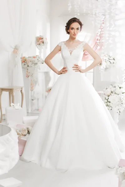 The beautiful woman posing in a wedding dress — 스톡 사진