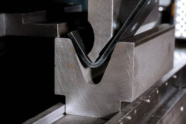 working with sheet metal on CNC hydraulic press brake. Bending sheet metal clipart