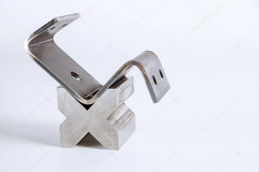 Sheet metal bending tool and equipment isolated on a white background. Special Bending machine Forming mold punch and die. Press brake tools, bend tools, press brake punch and die.