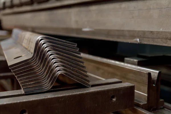 A stack of sheet metal products after processing on a bending machine.