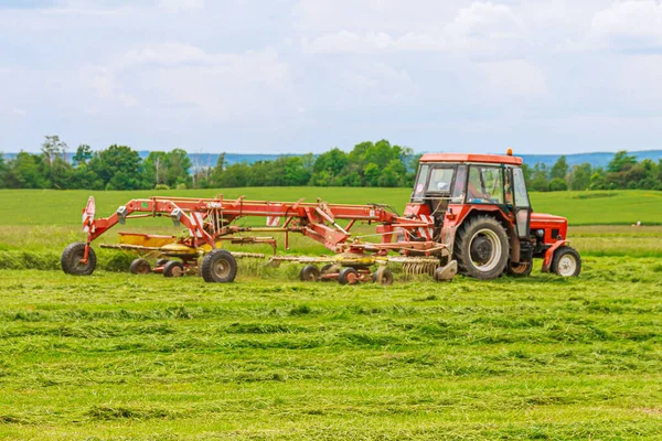 Een Trekker Met Een Draaihark Harkt Vers Gemaaid Gras Voor — Stockfoto