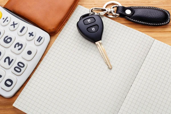 Car key on blank notebook with pocket money — Stock Photo, Image