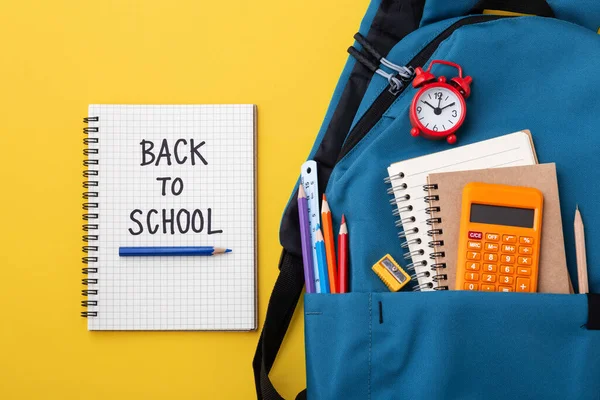 Back School Text Notebook Blue School Backpack Yellow Background — 스톡 사진